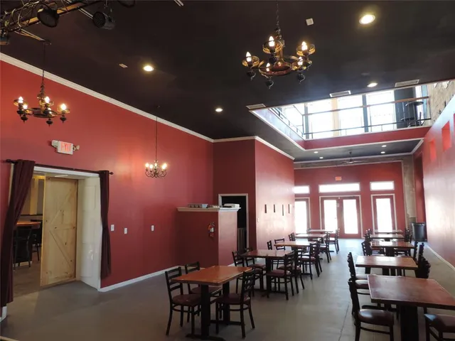 a view of a dining room with furniture and chandelier