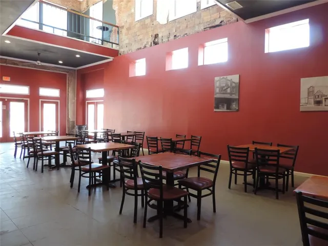 a view of a dining hall with many windows