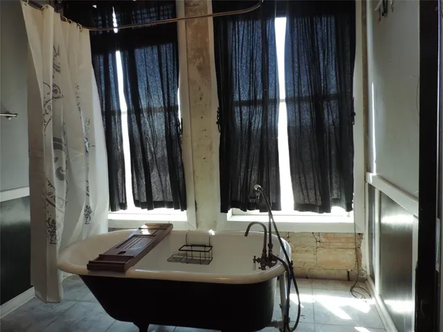 a bathroom with a shower and a sink