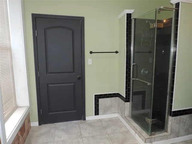 a bathroom with a toilet a sink and shower