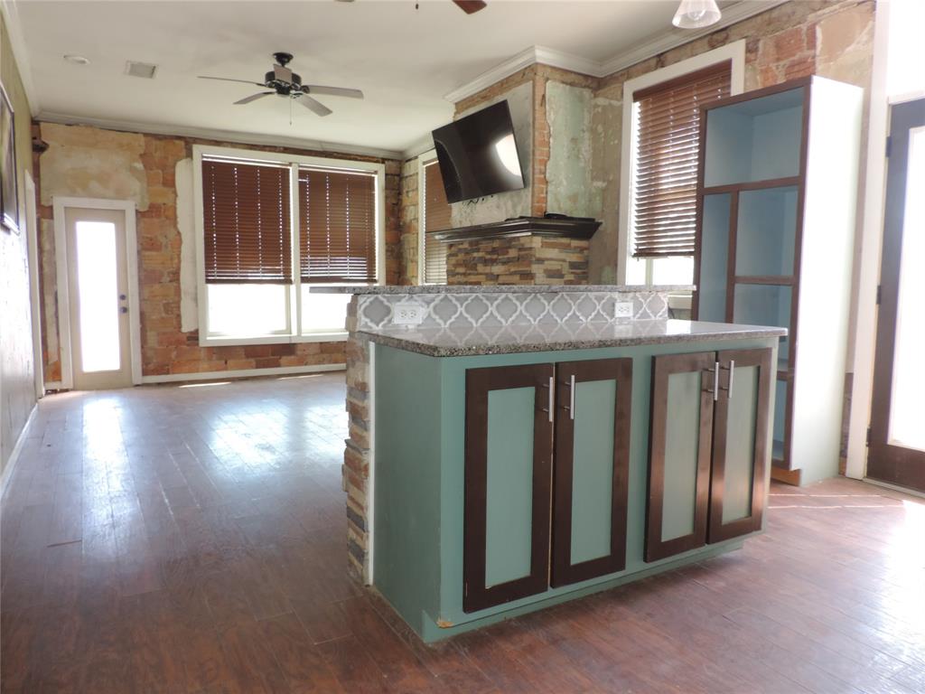 112 South Austin Street Ranger, TX 76470 - Photo 37 of 40 a view of a livingroom with wooden floor and a flat screen tv