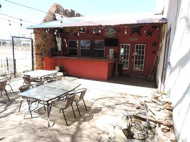 a view of a chairs and table in a patio