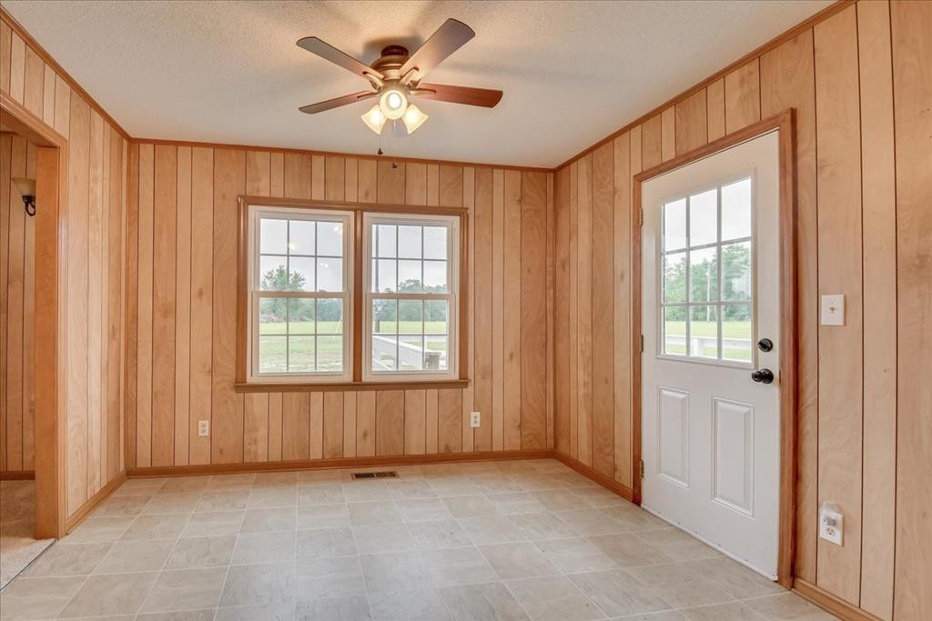 1673 Coleman Bridge Road Wagener, SC 29164 - Photo 16 of 45 an empty room with chandelier fan and windows