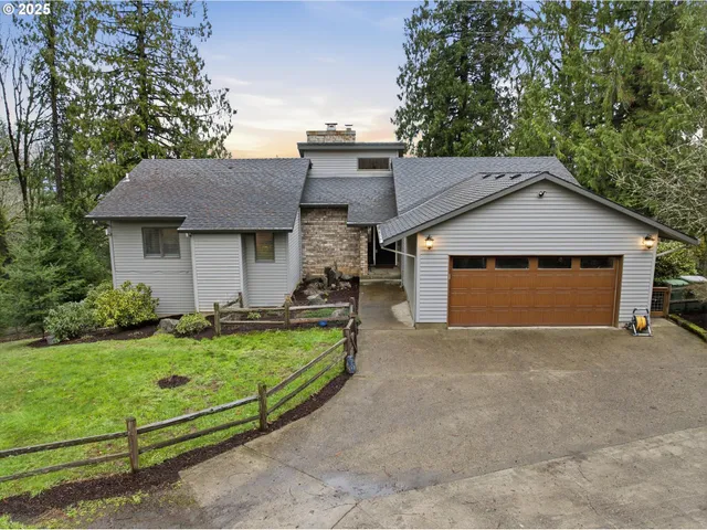 a front view of a house with a garden and yard