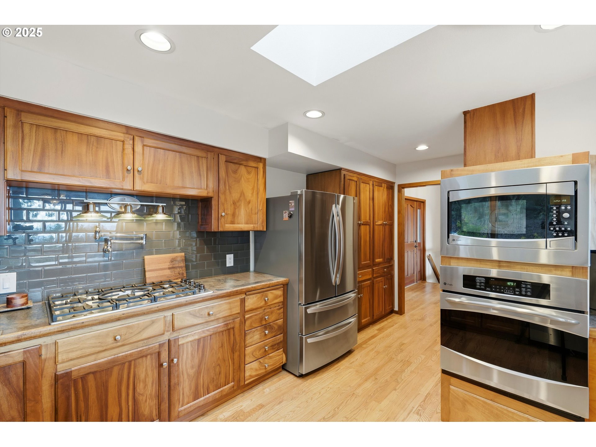 21645 Southwest McCormick Hill Road Hillsboro, OR 97123 - Photo 11 of 47 a kitchen with stainless steel appliances a refrigerator and a stove top oven