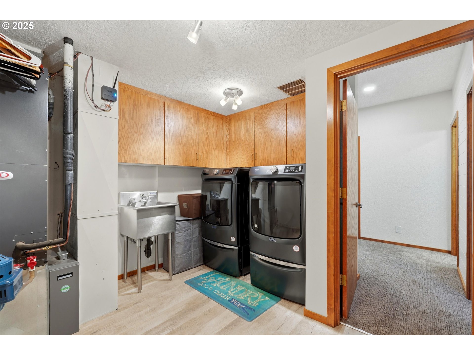 21645 Southwest McCormick Hill Road Hillsboro, OR 97123 - Photo 30 of 47 a kitchen with stainless steel appliances kitchen island granite countertop a refrigerator and a sink