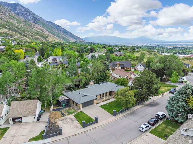 4150 Dover Lane Provo, UT 84604 - Photo 43 of 44 Ranch-style residence featuring a dark gray roof, attached two-car garage, and a manicured front lawn
