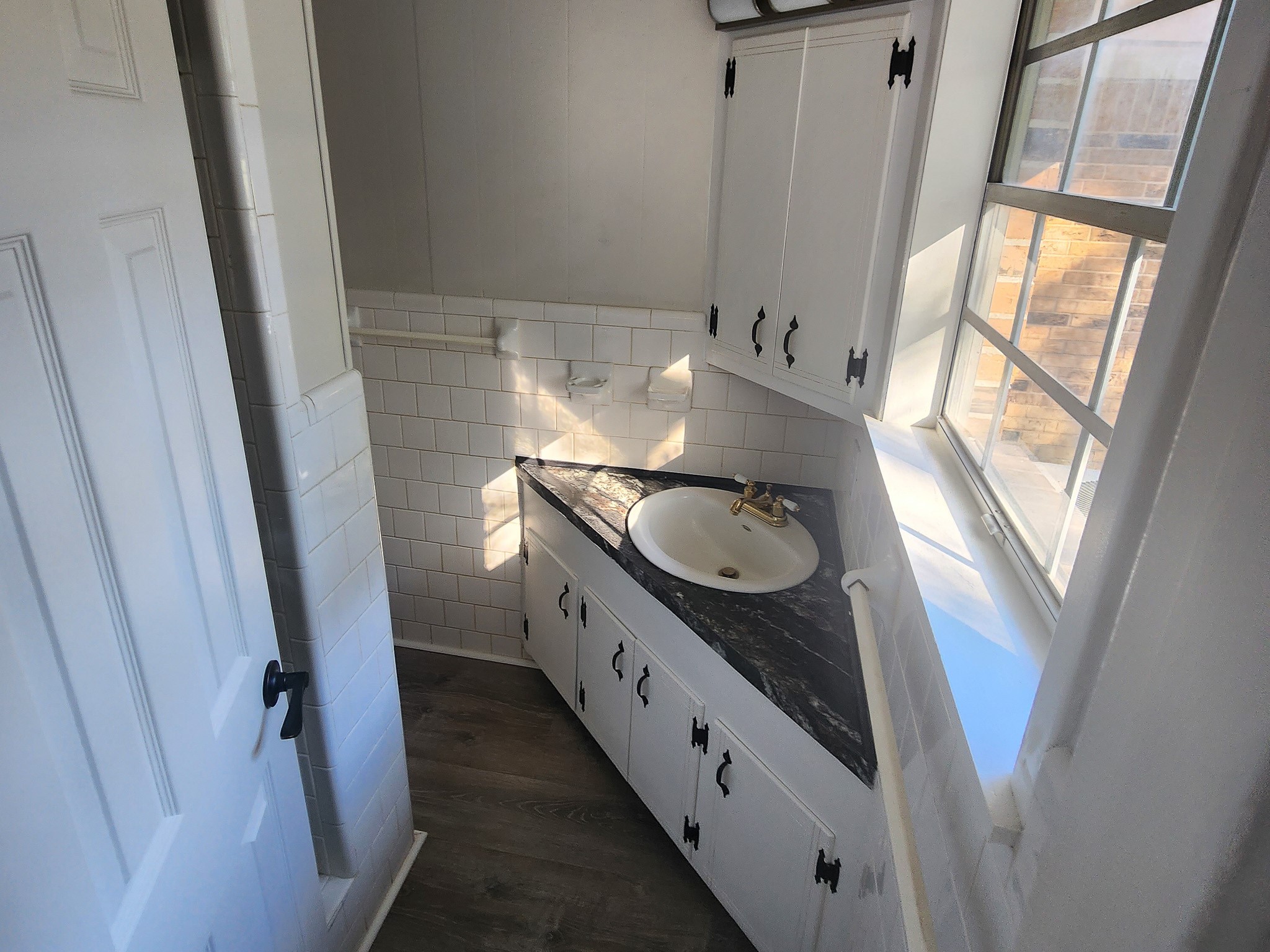 201 Verna Street Jasper, TX 75951 - Photo 15 of 27 Experience comfort in this charming en suite bathroom, featuring sleek cabinetry, abundant natural light, and a stylish countertop.