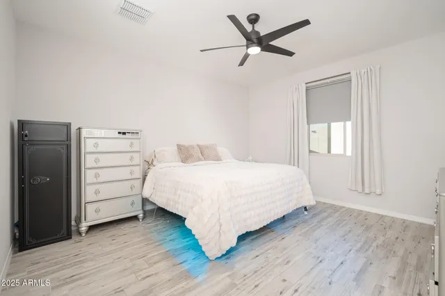 a bedroom with a bed and a dresser