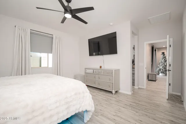 a bedroom with a bed window and a flat screen tv