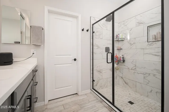a bathroom with a shower and a sink