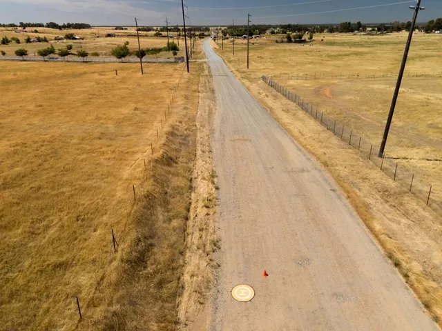a view of a lake with sunset in background