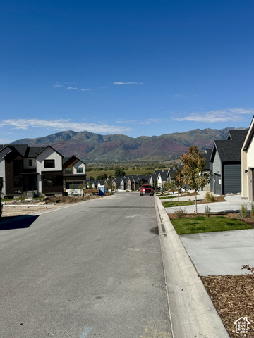 567 East Rimrock Lane Heber City, UT 84032 - Photo 15 of 16 Mountain backdrop, newly constructed neighborhood with modern architecture, paved street, concrete sidewalks, and landscaped front yards