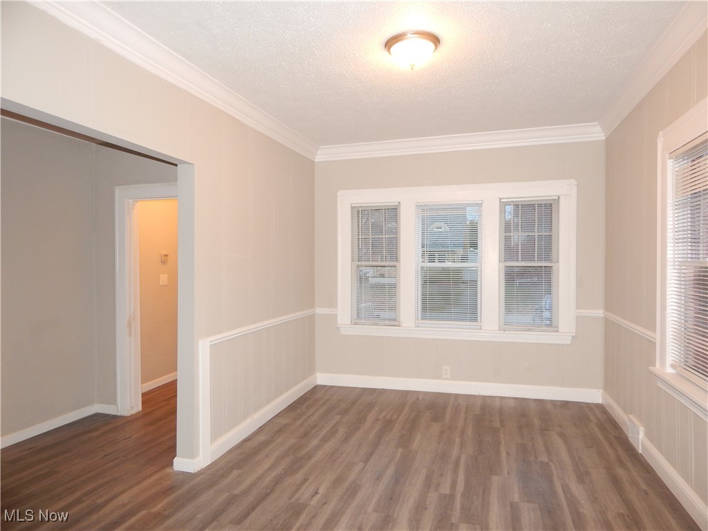 3845 Summit Park Road Cleveland Heights, OH 44121 - Photo 2 of 15 Dining room with a textured ceiling, ornamental molding, and wood finished floors