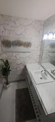 a bathroom with a sink a toilet and a mirror