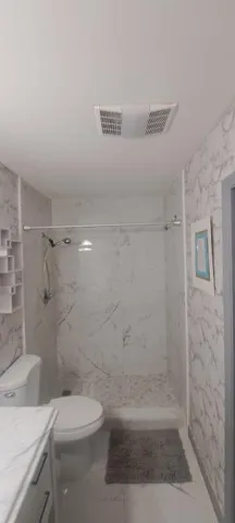 a bathroom with a shower and a toilet