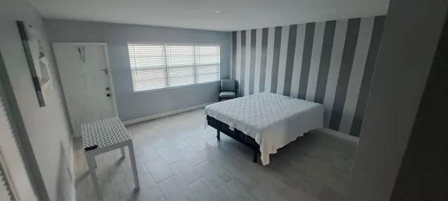 a bedroom with a bed and window