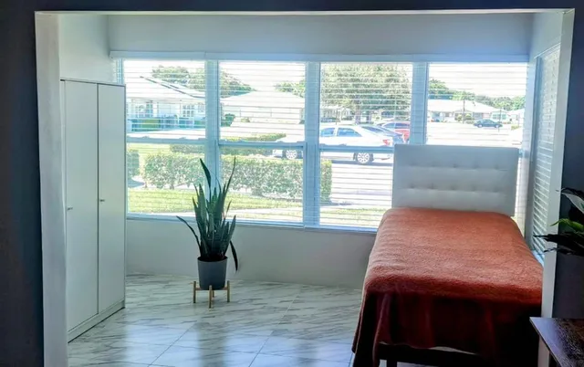 a room with a bed and a window