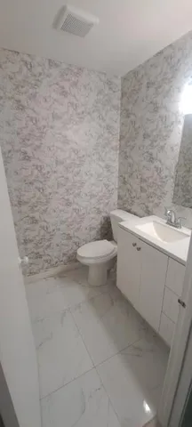 a bathroom with a toilet and a sink