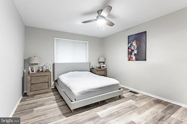 a bedroom with a large bed and a chandelier
