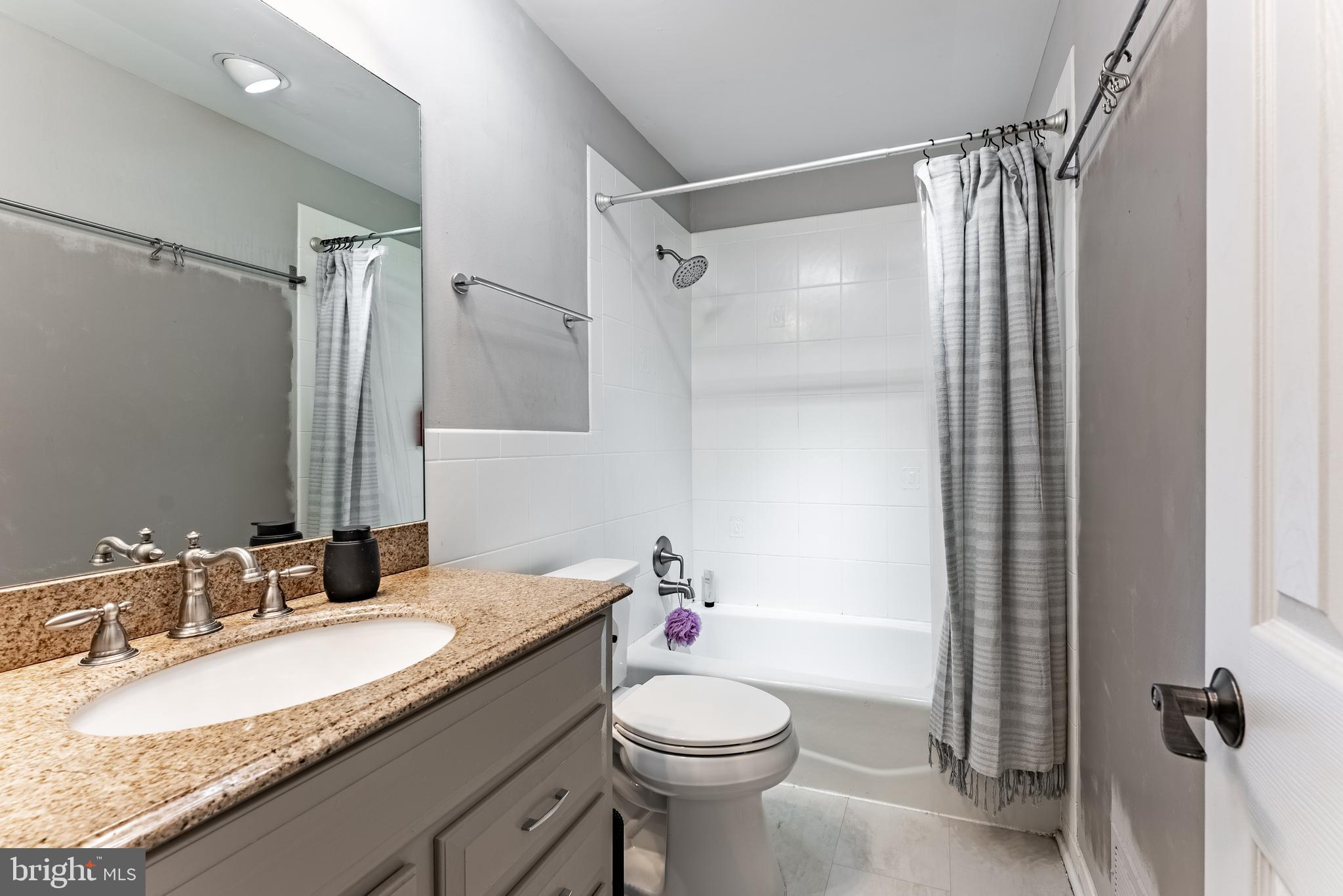 2045 Winged Foot Court Reston, VA 20191 - Photo 12 of 39 a bathroom with a granite countertop sink toilet and shower
