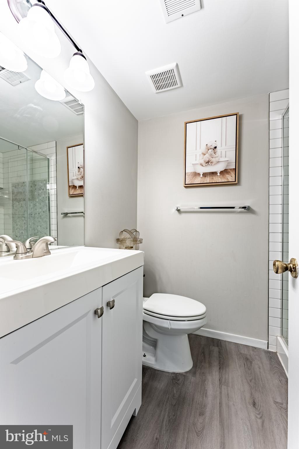 2045 Winged Foot Court Reston, VA 20191 - Photo 15 of 39 a bathroom with a toilet sink and mirror