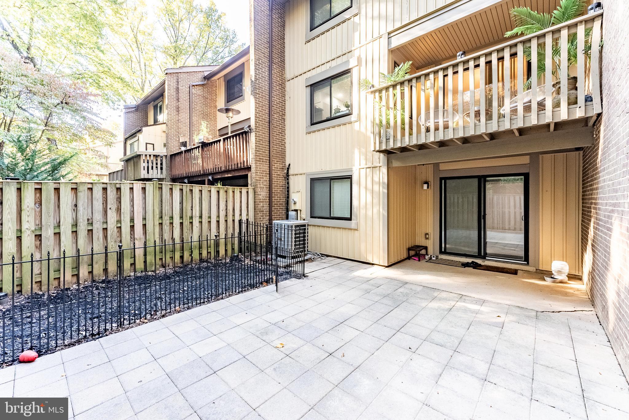 2045 Winged Foot Court Reston, VA 20191 - Photo 17 of 39 a view of a brick house with wooden fence