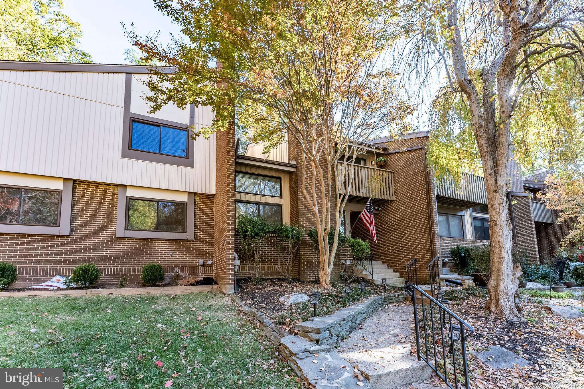 2045 Winged Foot Court Reston, VA 20191 - Photo 19 of 39 a view of a brick house with a yard and large tree