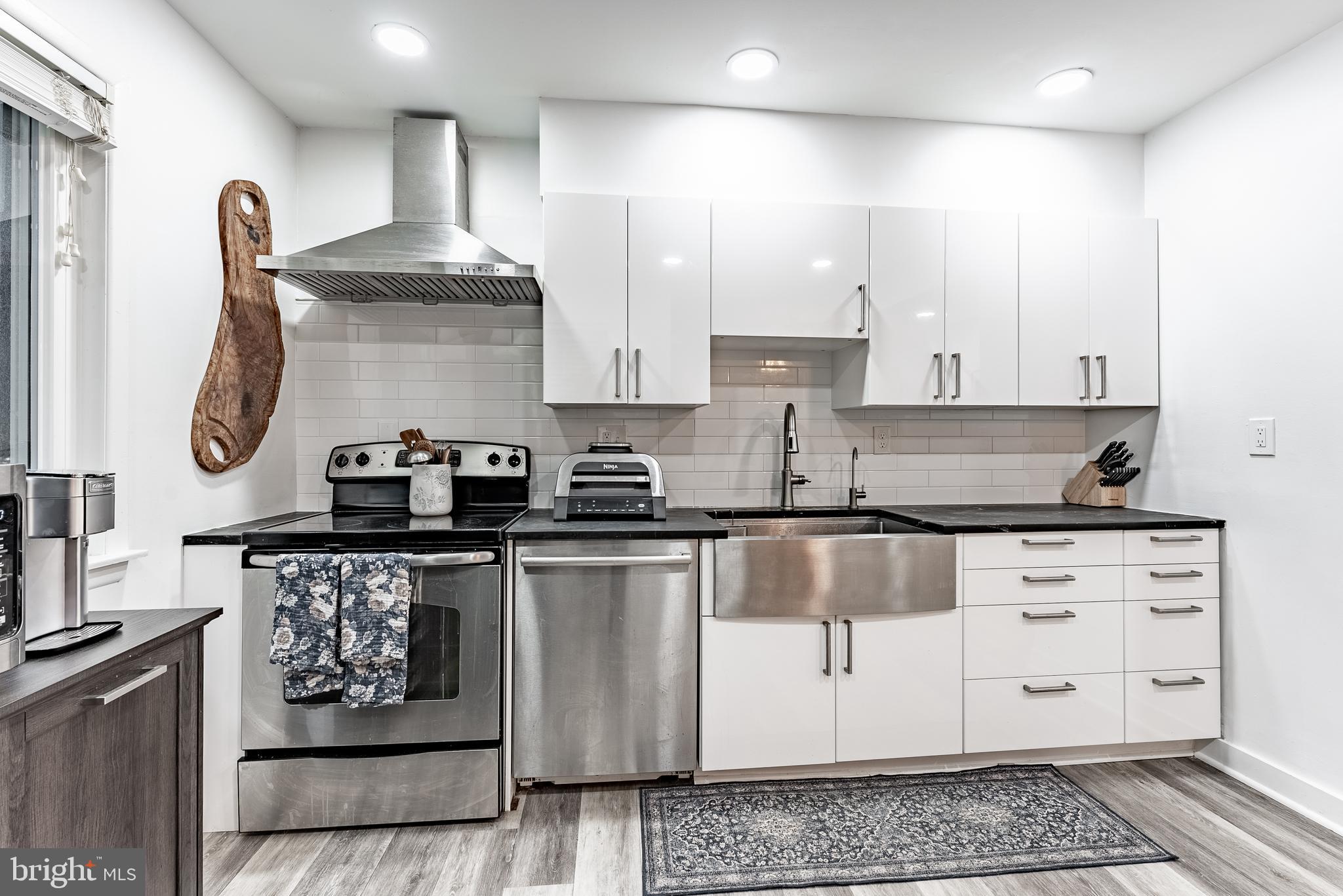 2045 Winged Foot Court Reston, VA 20191 - Photo 2 of 39 a kitchen with stainless steel appliances granite countertop a stove a sink and a microwave