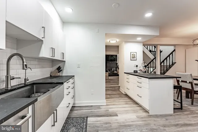 a kitchen with granite countertop a sink and cabinets