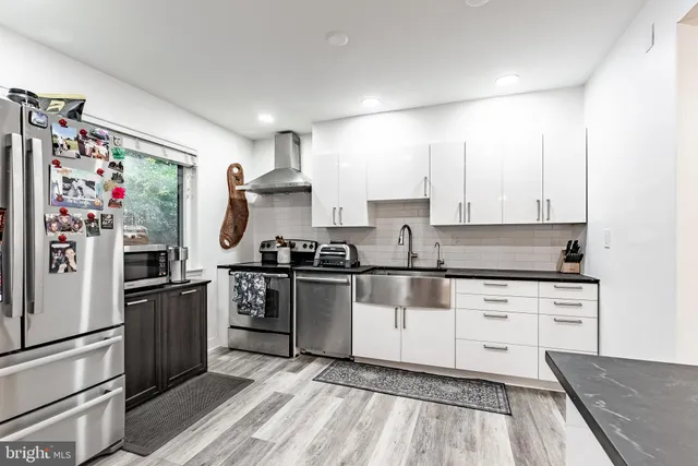a kitchen with granite countertop stainless steel appliances and wooden cabinets