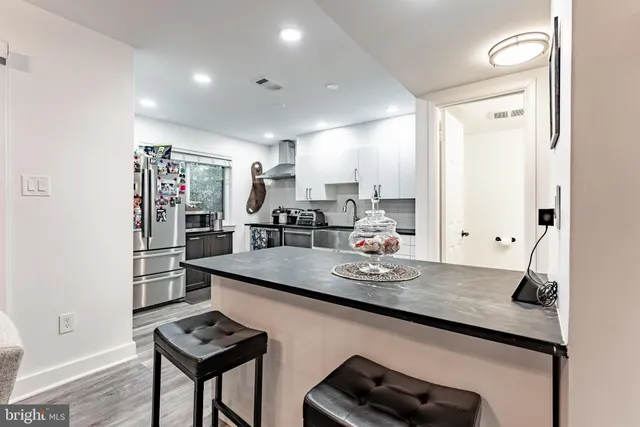 a kitchen with stainless steel appliances granite countertop a sink stove and cabinets