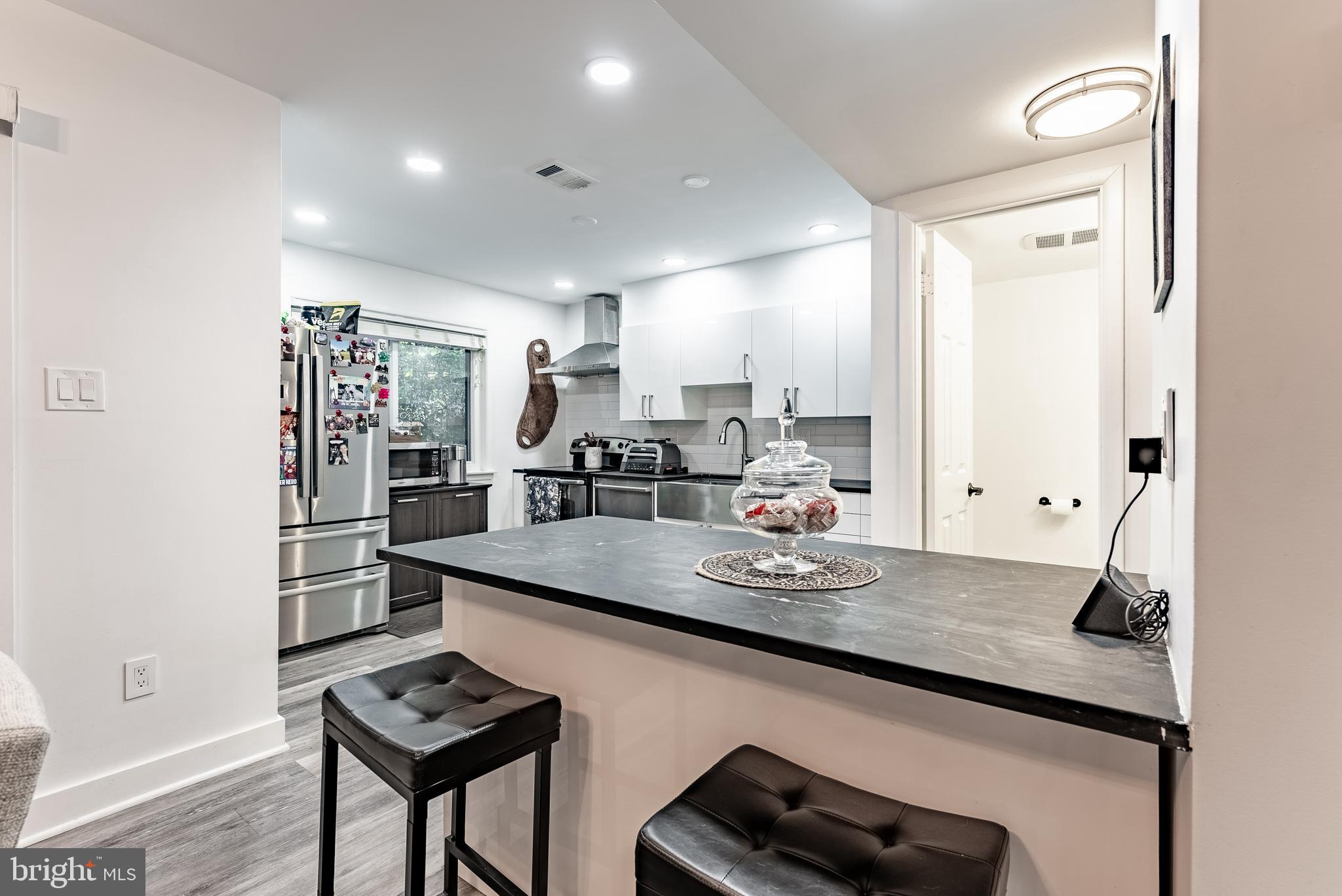2045 Winged Foot Court Reston, VA 20191 - Photo 3 of 39 a kitchen with stainless steel appliances granite countertop a sink stove and cabinets