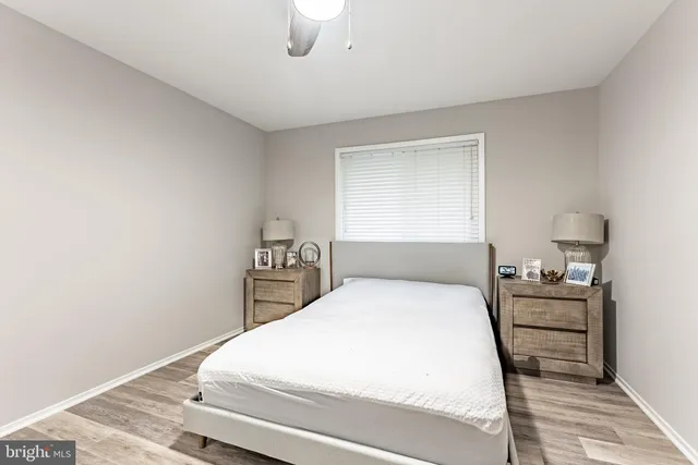 a bedroom with a bed and a night stand