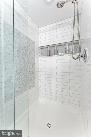 a bathroom with a bathtub and shower