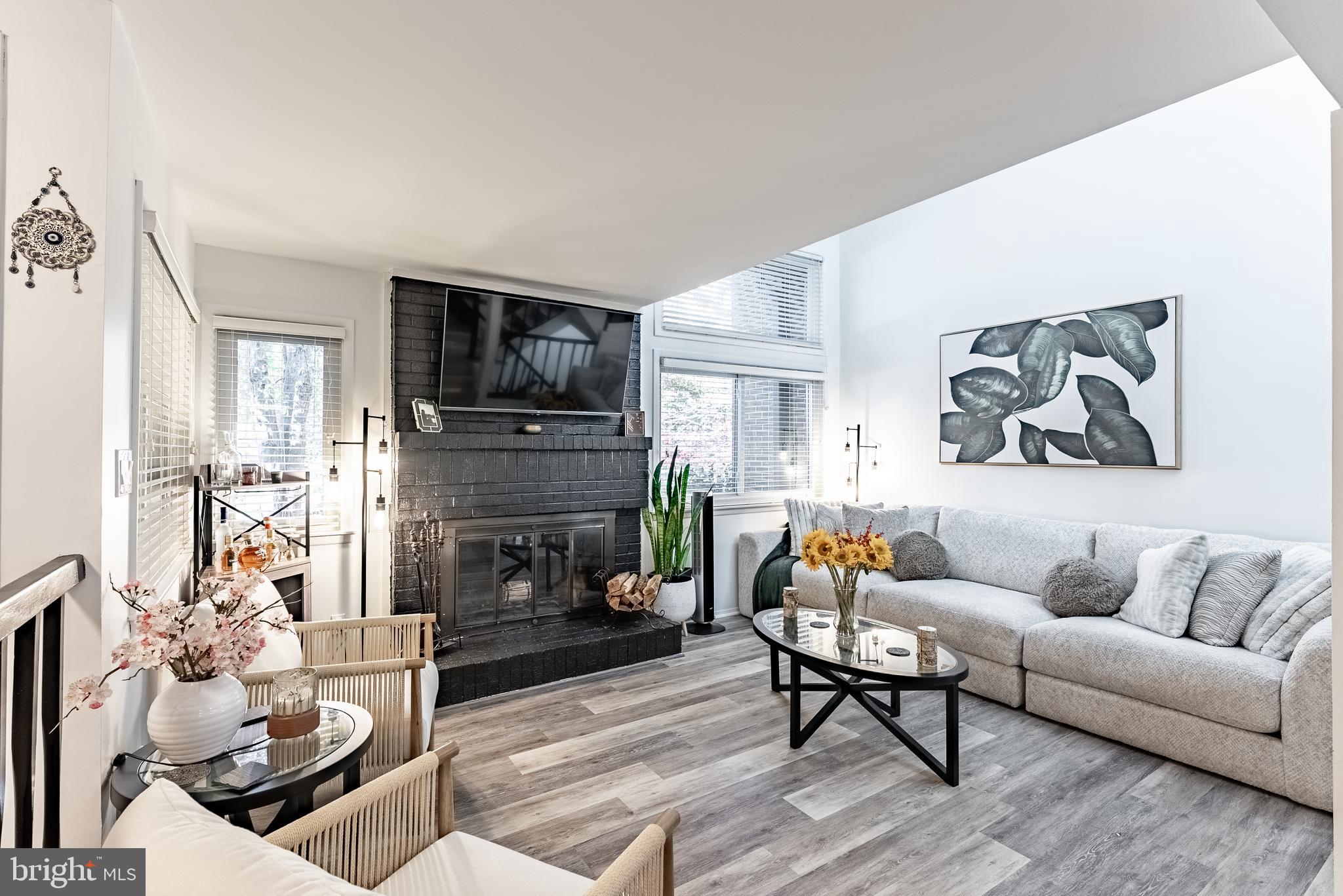 2045 Winged Foot Court Reston, VA 20191 - Photo 5 of 39 a living room with furniture a fireplace and a flat screen tv