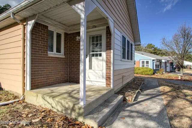 a view of a brick house with a small yard