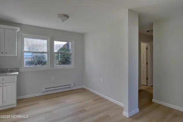 a view of a room with wooden floor and window