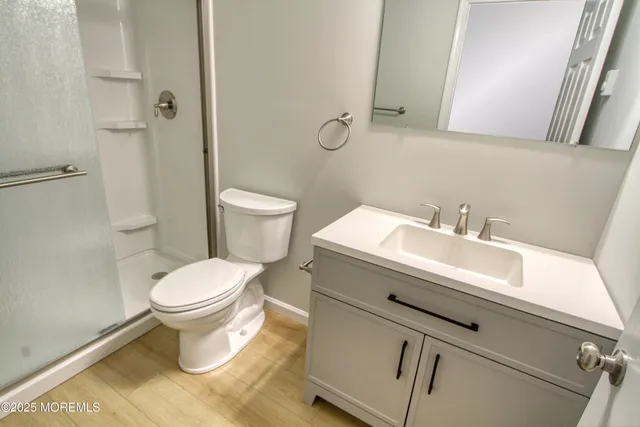 a bathroom with a sink toilet and shower