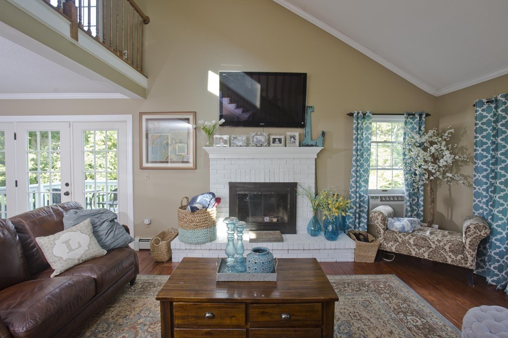 2 Sunset Rock Road Wilbraham, MA 01095 - Photo 10 of 30 a living room with furniture a fireplace and a flat screen tv