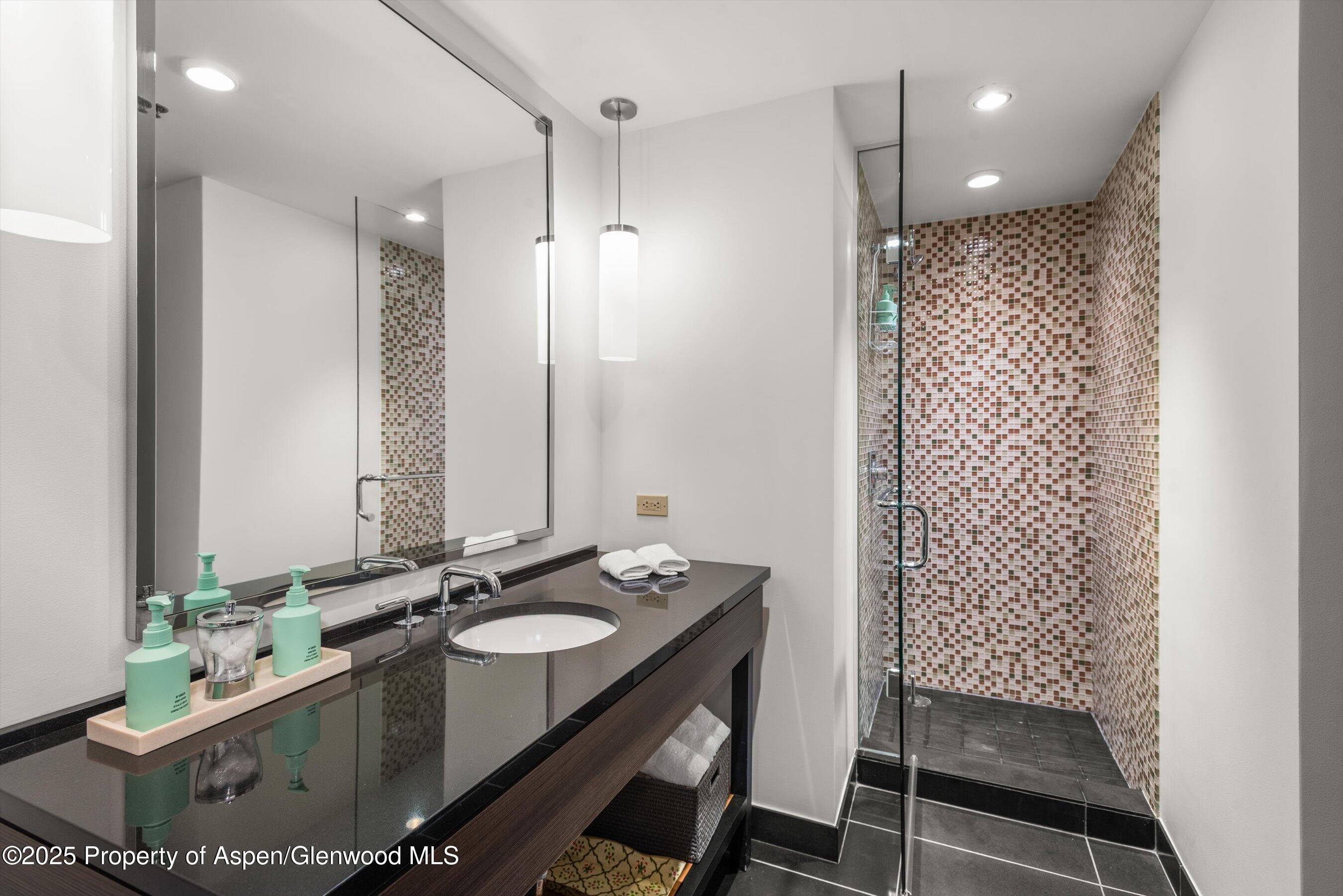 130 Wood Road, Unit 625 Snowmass Village, CO 81615 - Photo 13 of 15 a bathroom with a sink double vanity and a mirror