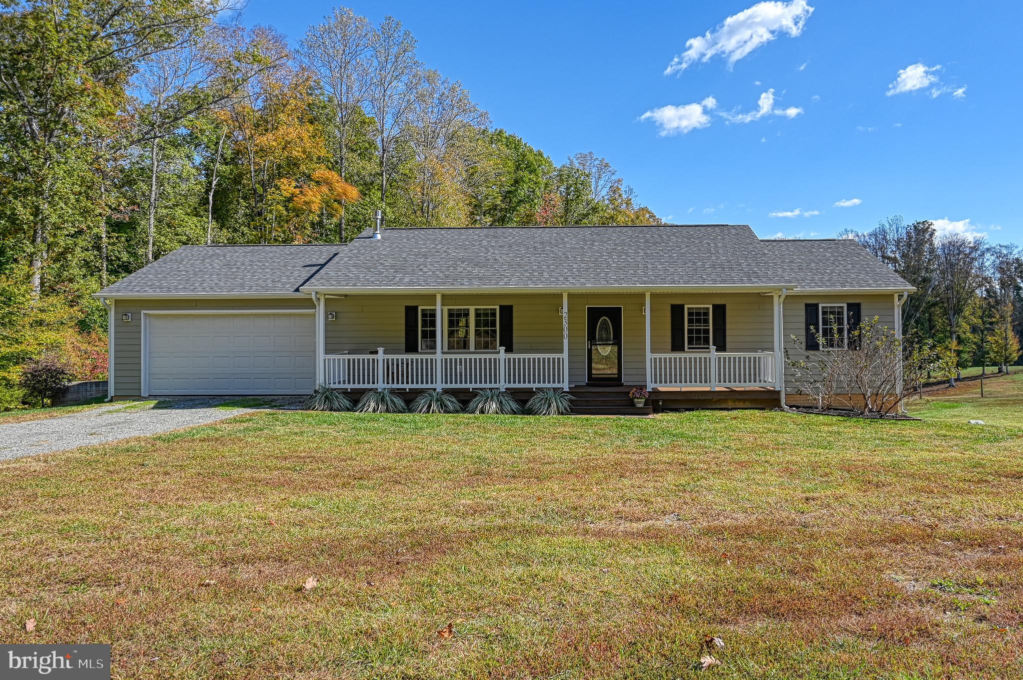 a house with huge green field in front of it
