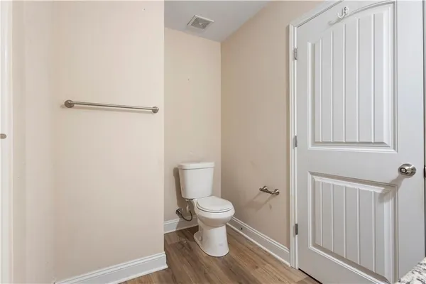 a white toilet sitting next to a small bathroom
