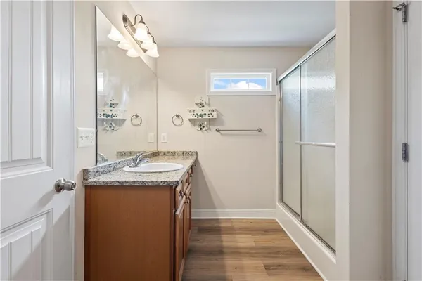 a bathroom with a granite countertop sink and a mirror