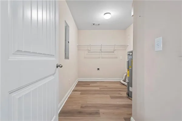 an empty room with windows and closet