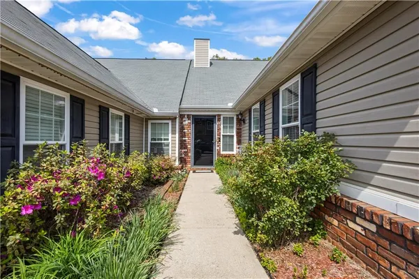 a view of a house with potted plants