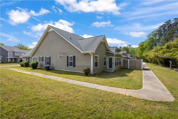 a view of a house with swimming pool and a yard