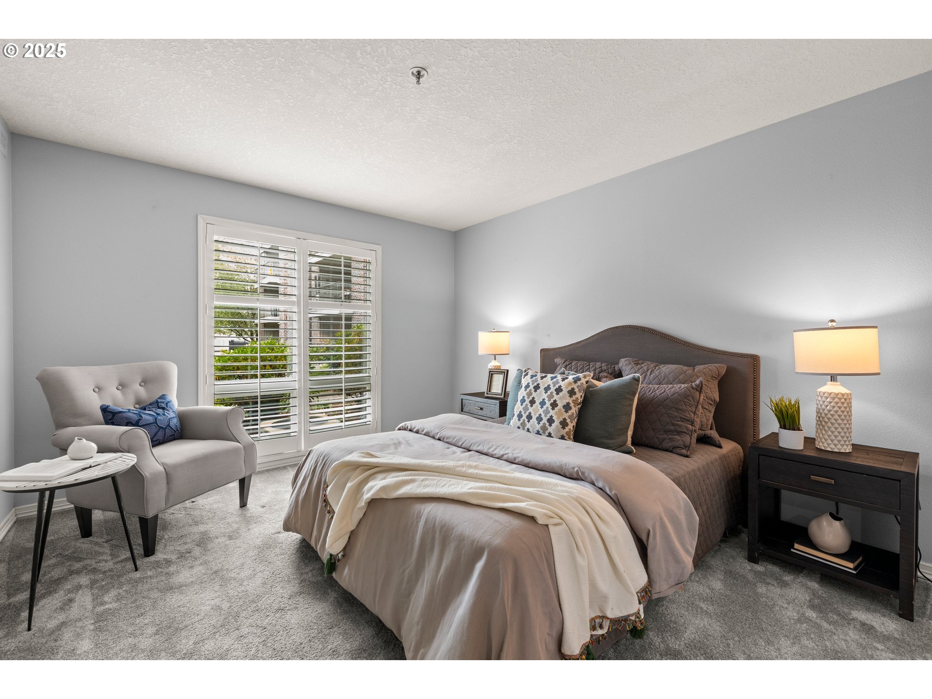 15420 Northeast Knott Street, Unit 2 Portland, OR 97230 - Photo 13 of 30 a bedroom with a bed a couch and a window