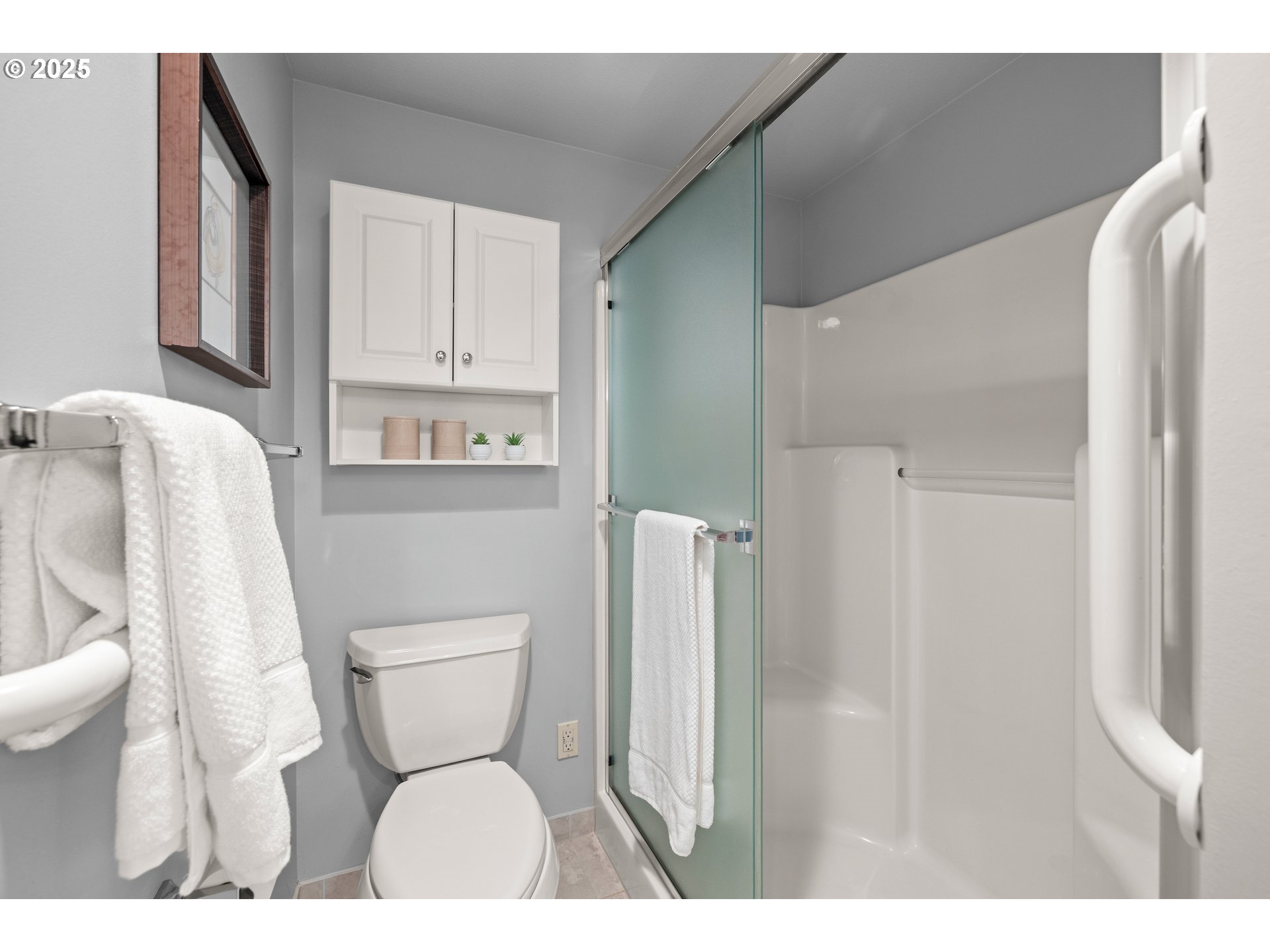 15420 Northeast Knott Street, Unit 2 Portland, OR 97230 - Photo 19 of 30 a white toilet sitting next to a bathroom sink