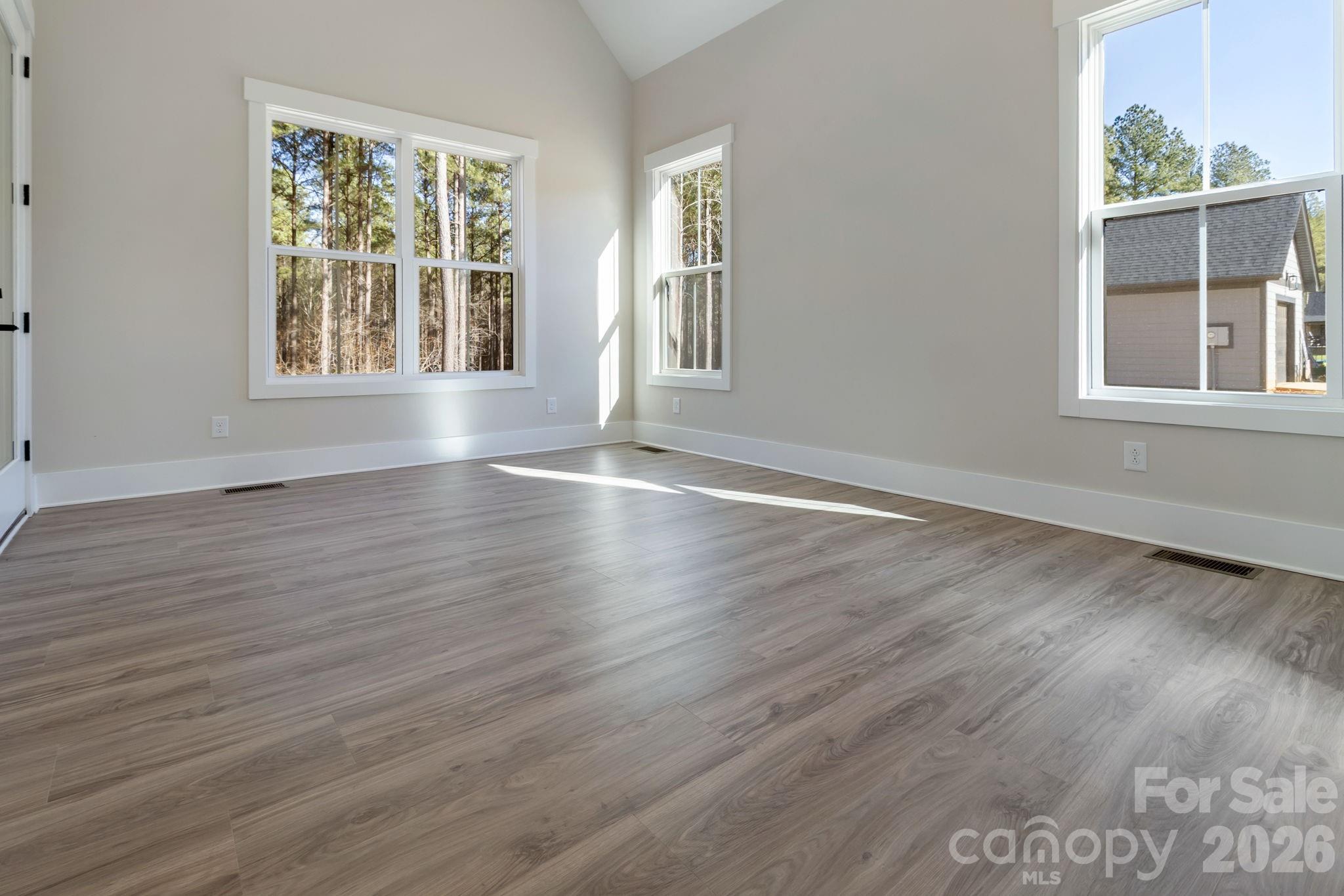 1359 Glasscock Road, Unit 1 Rock Hill, SC 29730 - Photo 17 of 40 a view of an empty room with wooden floor and a window